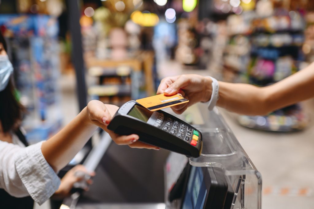 Swiping a credit card at a beachside business.