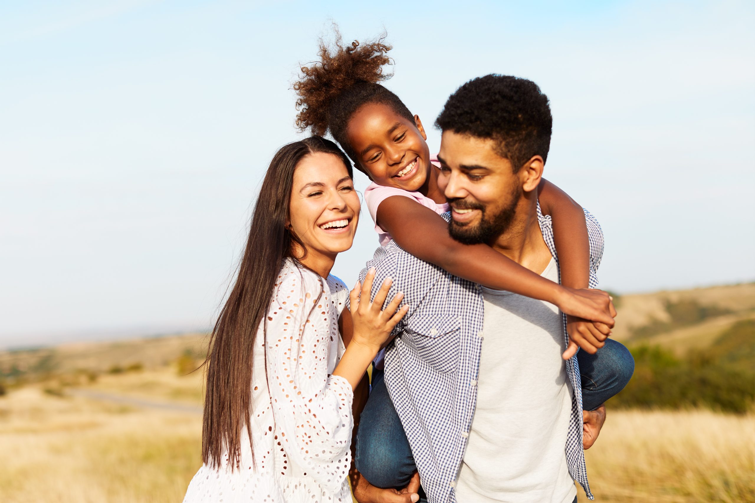 blended family happy mother father with girl cheerful field outdoor