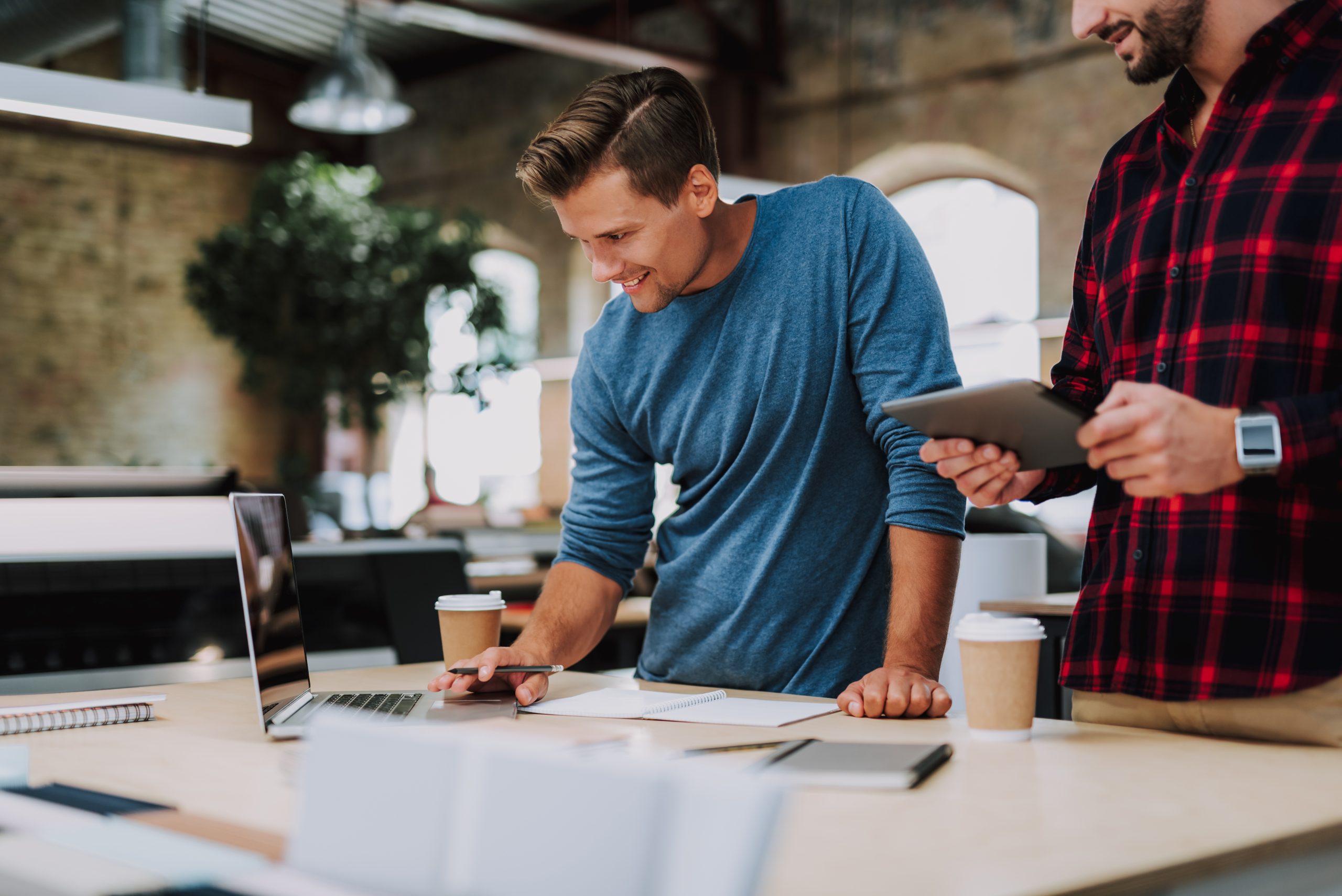 Happy man working on his laptop towards starting a business